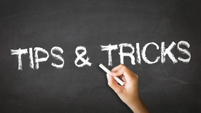 A person drawing and pointing at a Tips and Tricks Chalk Illustration
